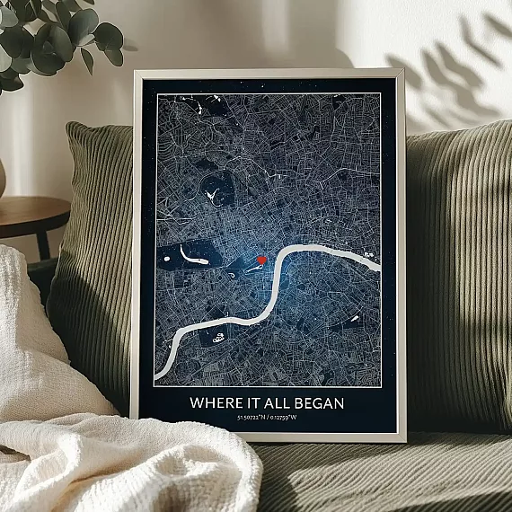 Where It All Began night map poster with a heart marking a special location, displayed on a cozy sofa.