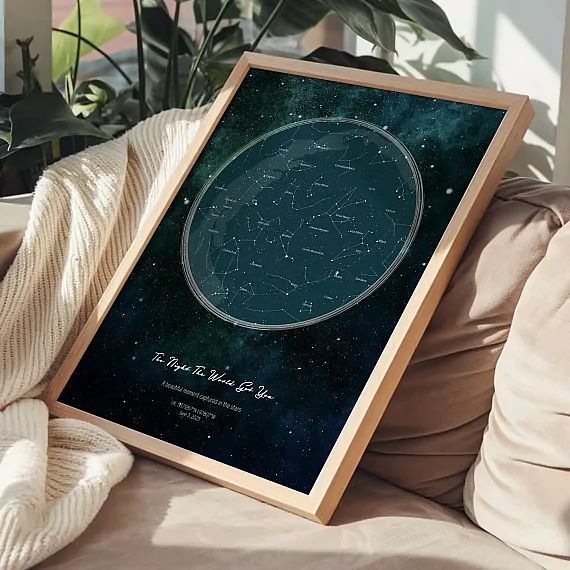 Framed Birthday Star Map with galaxy background displayed on sofa with blanket.