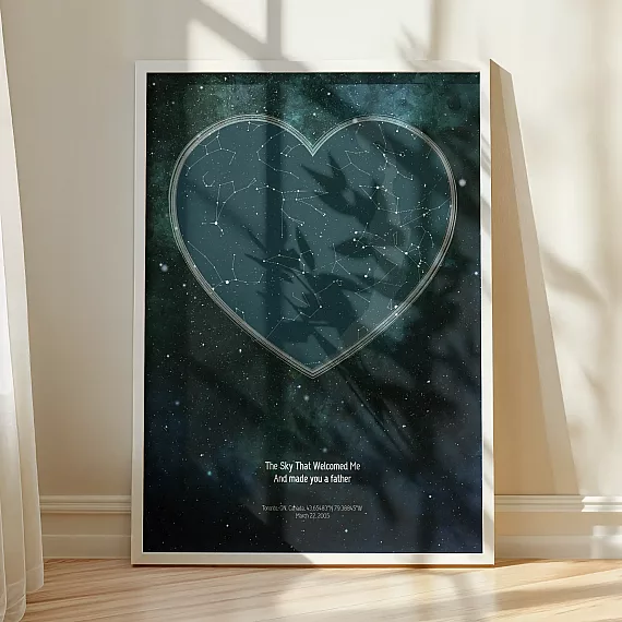 Heart-shaped The Day You Became My Daddy constellation poster framed in white and displayed in warm sunlight.