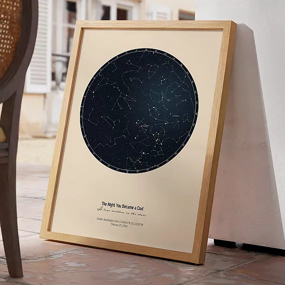Minimalist The Day You Became My Daddy star map print leaning against a wall in a bright interior.