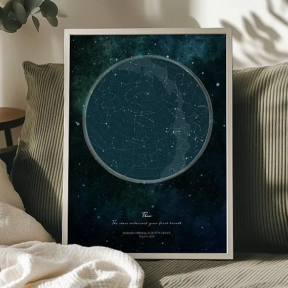 Large personalized birth star map poster displayed on a sofa.