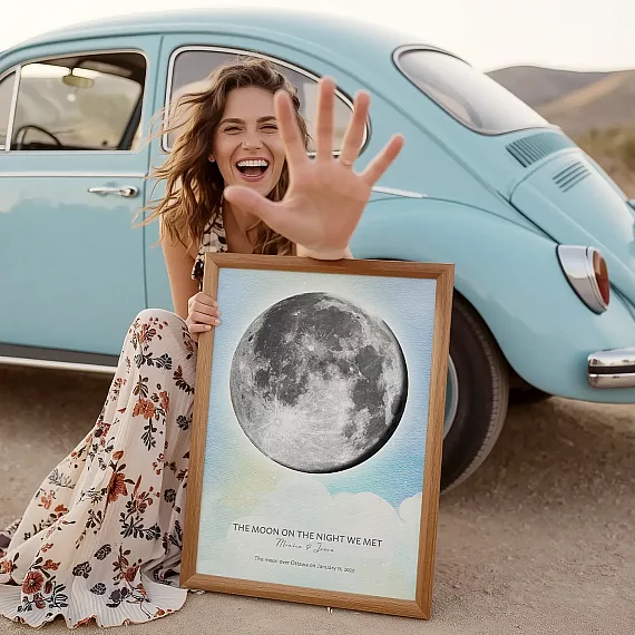 Man hanging a personalized Moon on the Night We Met print featuring the exact moon phase.
