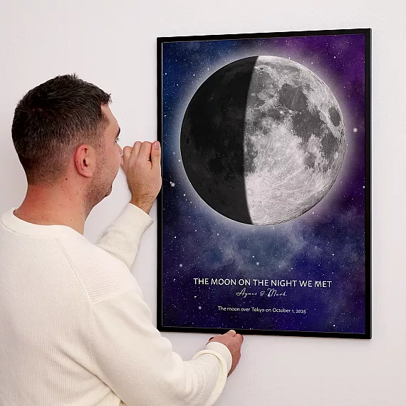 Personalized Moon on the Night We Met print featuring a half moon displayed on a wall.