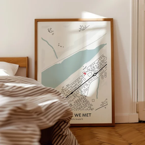 Minimalist “Where We Met” map poster leaning against a wall in a bedroom with a subtle location marker.