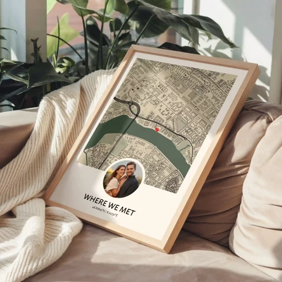Personalized “Where We Met” map poster with a couple’s photo and marked location displayed on a sofa.