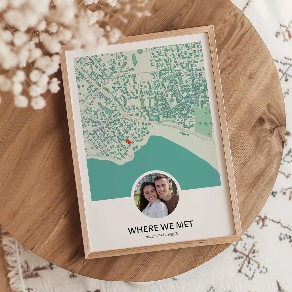 Framed “Where We Met” map poster with a couple’s photo and location marker placed on a wooden table.