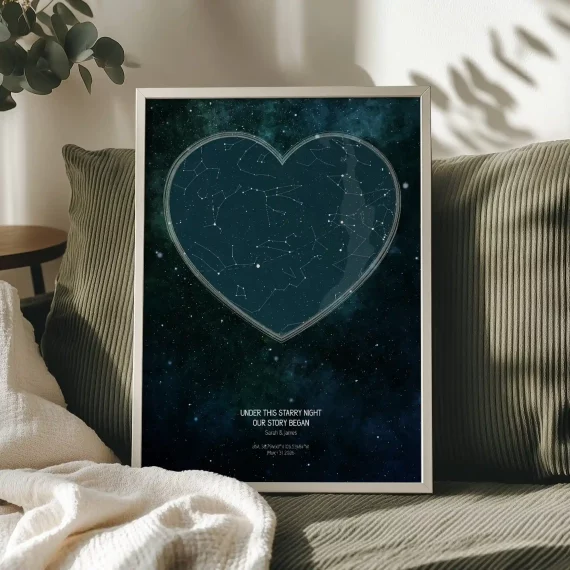 Personalized star map poster with a heart-shaped constellation design displayed on a sofa.