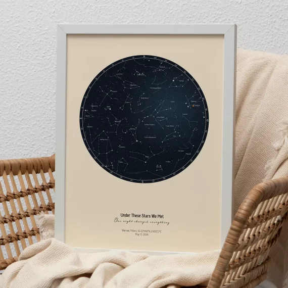 Minimalist framed Stars The Night We Met print with circular star map displayed on a woven chair with cozy textiles.