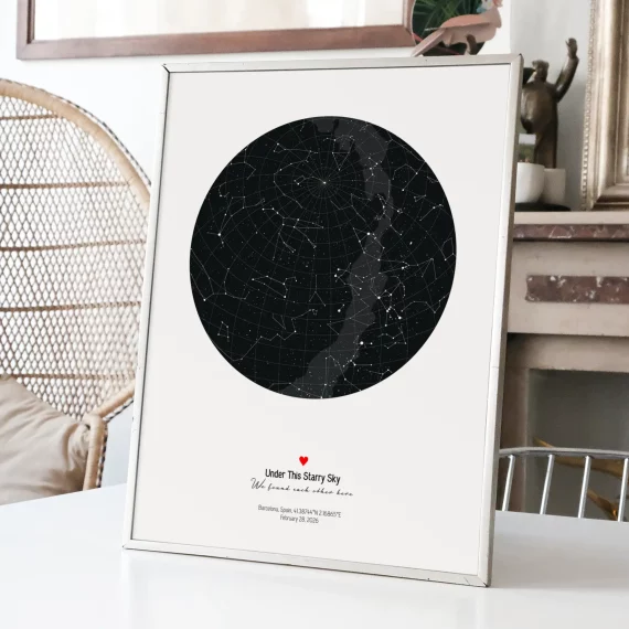 Framed Stars The Night We Met celestial print with dark star map displayed on a white table in a cozy living room.