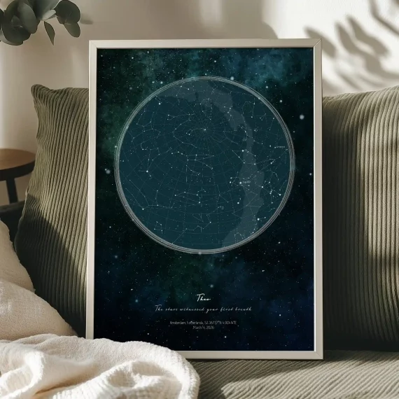 Large personalized birth star map poster displayed on a sofa.