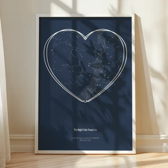 Framed Stars The Night We Met heart constellation print standing against a wall in warm natural sunlight.