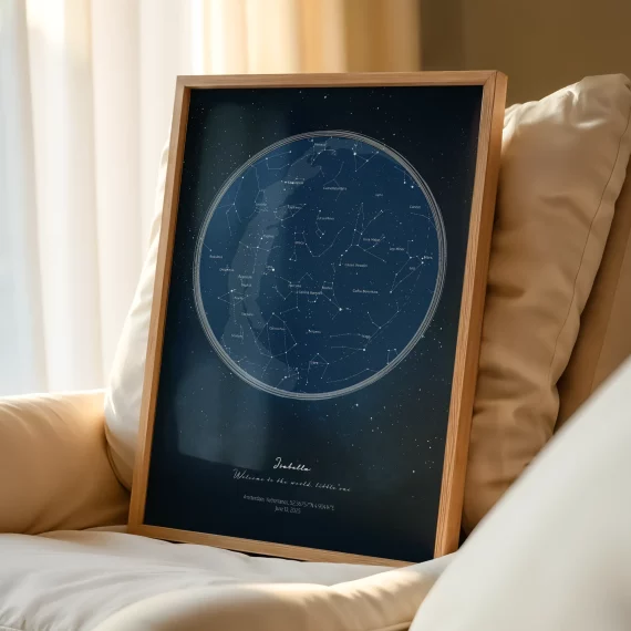 Framed custom constellation poster displayed on a couch with cushions.