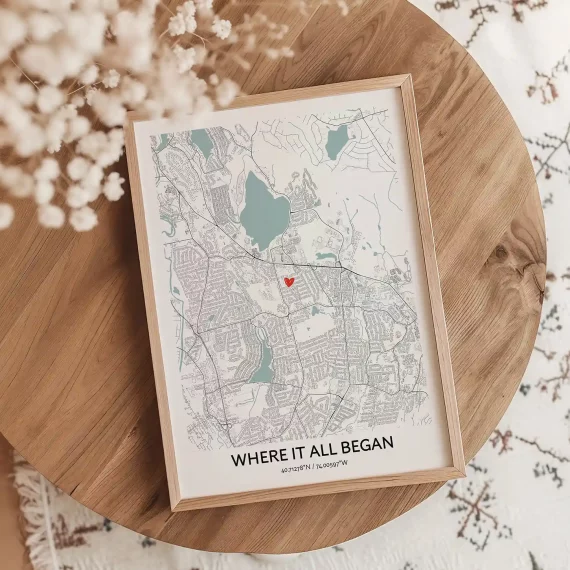 Where It All Began custom map poster on a wooden table with a heart marking a meaningful location.