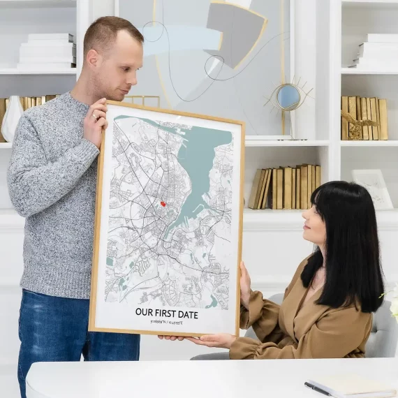 Couple sharing Our First Date Map poster showing a marked location from their first date.