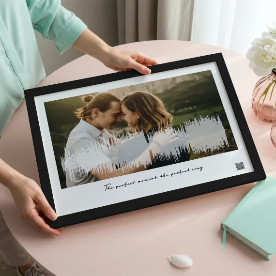 custom soundwave art print with couple photo and waveform held on table
