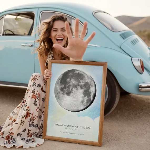 Man hanging a personalized Moon on the Night We Met print featuring the exact moon phase.
