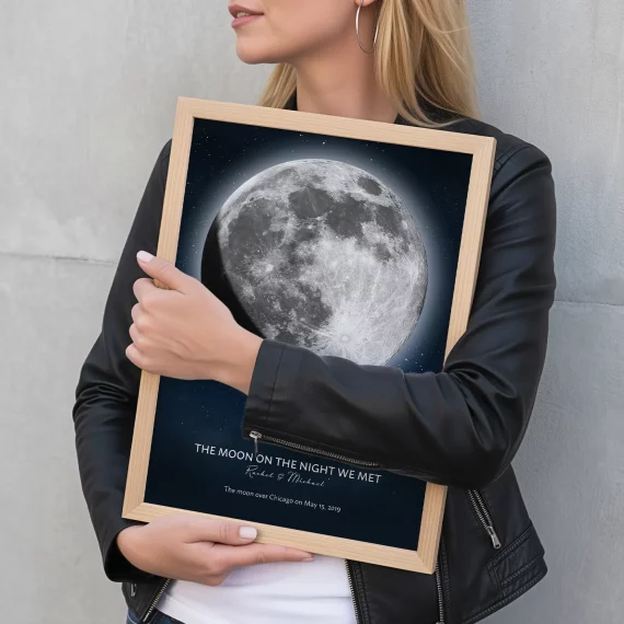 Woman holding a framed personalized Moon on the Night We Met print.