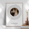 Framed first dance lyrics print with a couple's photo displayed on a shelf