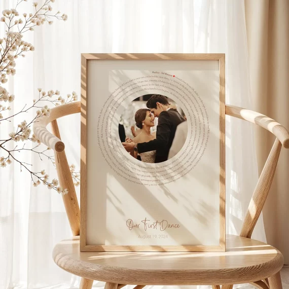 First Dance Song Lyrics with Photo poster displayed on a wooden chair with a couple’s wedding photo and lyrics.