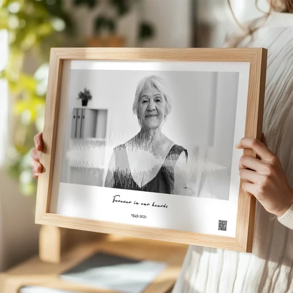 memorial voice recording wall art with black and white portrait and soundwave held by woman