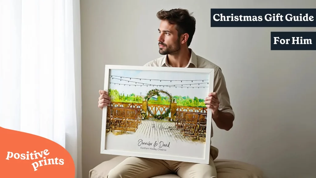 Personalized Christmas gift guide for him man holding custom watercolor wedding venue print with couple names meaningful wall art present