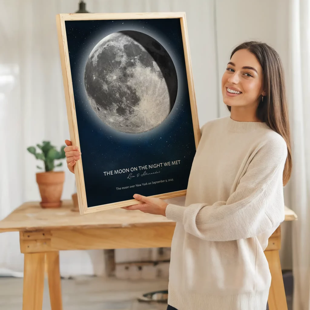 Woman holding a framed personalized moon phase print, a meaningful gift celebrating the night two people met