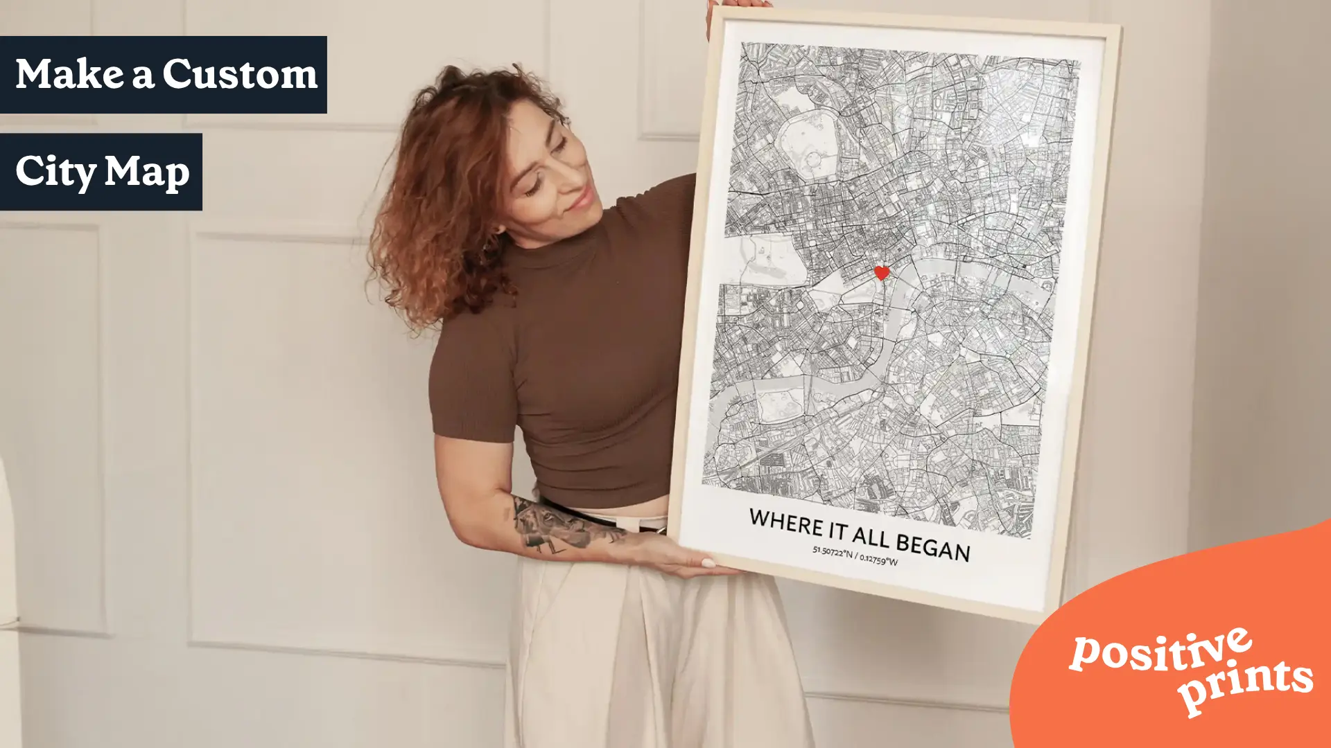 Woman holding a personalized city map poster with a custom message and red heart marking a meaningful location.